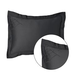 two black pillows with spider webs on the front and back, both in satin