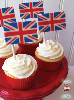 cupcakes decorated with british flags on a red plate