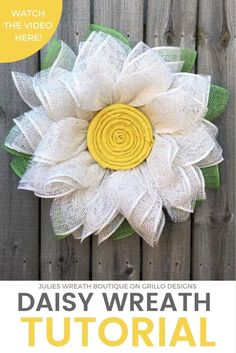 the daisy wreath is made with white and yellow fabric