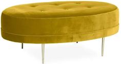 a round yellow ottoman with metal legs