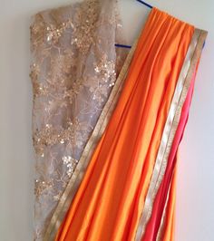 "A soft orange saree from Gia paired with a stylish sequin net blouse. The saree is a perfect accent to your beauty with is dreamy blouse and soft orange color. The understated borders give a classic look to this saeee. Saree width :44\" Length :5.5 meters Blouse piece: 1 meter 44\" wide plus 1 meter gold satin for lining. Shipping time is 4-5 days. Please don't hesistate to convo me if you have any questions. We can stitch the blouse for you as an extra service." Sequin Lehenga, Silk Shirt Blouses, Net Blouse, Big Skirts, Brocade Skirt, Choli Blouse, Orange Saree, Net Blouses, Soft Orange