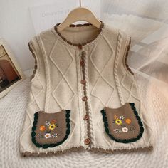 The ultimate vintage inspired grandma vest combining all the essential details like scalloped edges, wooden buttons and cute floral embroidery! Soft and cozy with a button up front, scalloped edges, cable knit detailing and front pockets and round neckline. 38" chest, 21.5" length Grandma Vest, Cottagecore Clothes, Pocket Vest, Cottagecore Vintage, Mini Dress Formal, Graduation Outfit, Wooden Buttons, Sweater Set, Plus Dresses