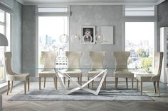 a glass dining table surrounded by beige chairs in front of a large window with city view