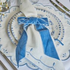 a blue and white place setting on a table