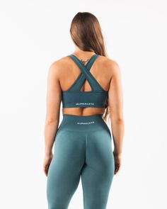 HIGHLIGHTS. Removable cups. Scrunch detailing in the center. Medium to high impact. Moisture-wicking, breathable fabric. V-shaped neckline and crossing back straps. Unbelievably soft texture. Proprietary seamless blend of fine Italian yarn. Alphalete core wordmark knitted in white. Reinforced binding arm and neckline finishing FIT SUGGESTION. This item has a compression fit.. If you are between sizes, we recommend sizing up.. Model is 5’10”/177.8cm, wearing a size S with a 36”/91.5cm bust.. MATE Neckline Finishing, Hip Hip, Ombre Effect, Womens Bras, Soft Texture, Sporty Style, Back Strap, V Shape, Moisture Wicking