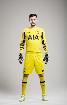 a man in yellow soccer uniform posing for the camera