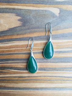 A pair of vintage dark green jade earrings. The teardrop-shaped earrings are made from quality green jade and 925 sterling silver hooks. The big emerald-like green jade drops are heavy-duty, comes with antique silver hooks. It's truly a great combination of modern minimalistic design and ancient Chinese royalty taste. Some highlights of this elegant and fancy dangle silver jade earrings are: *High-quality materials Quality green jade, 925 sterling silver. Great for sensitive skins and ensure lon Teardrop Jade Earrings For Formal Occasions, Vintage Green Jade Earrings, Green Vintage Sterling Silver Earrings, Vintage Green Sterling Silver Earrings, Formal Green Sterling Silver Teardrop Earrings, Formal Green Teardrop Sterling Silver Earrings, Green Sterling Silver Teardrop Earrings For Formal Occasions, Vintage Teardrop Gemstone Earrings, Teardrop Jade Earrings