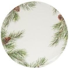 a white plate topped with pine cones and evergreen needles on it's rim, against a white background