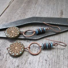 "This listing is for these beautiful Boho style earrings with hypoallergenic, pure titanium ear wire (or copper). The beads are a mix of turquoise blue and bronze glass. The large bead on these is an 18mm star design coin bead with a bronze Picasso finish. These beads are all slightly different. The top beads are matching colors with 6x2mm spacer beads in alternating colors. The copper ring is a 15mm solid ring connector. These are 2.75\" in total length. The titanium ear wire will be a french s Adjustable Minimalist Copper Earrings, Hypoallergenic Copper Drop Earrings, Hypoallergenic Copper Dangle Jewelry, Blue Hypoallergenic Copper Earrings, Czech Beads Jewelry, Blue And Bronze, Boho Style Earrings, Titanium Earrings, Copper Ring