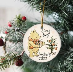 a personalized ornament hanging from a christmas tree