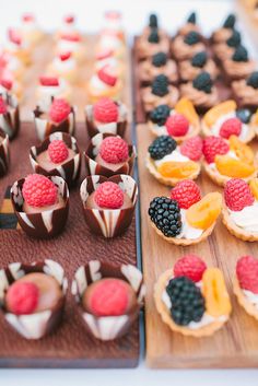 desserts are arranged on wooden trays and ready to be eaten