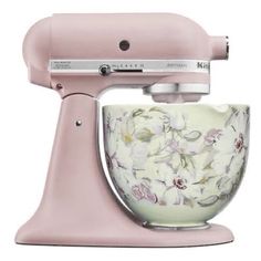 a pink mixer with white flowers on it