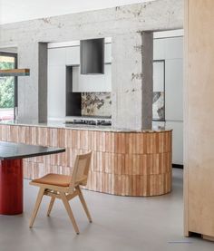 a kitchen with a table and chairs in it next to a counter top that is made out of plywood