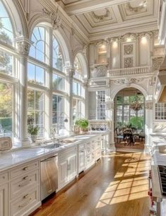 a large kitchen with lots of windows and white cabinets