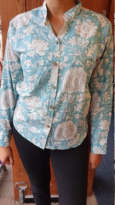 Made from 100 percent cotton, these beautifully coloured floral print shirts are perfect to wear over a pair of formal trousers or over jeans. You can turn these versatile shirts from office wear to evening/day wear by folding the sleeves and knotting up the ends. The sleeves also comes with two buttons to fit the wrist perfectly. This blouse is available in sizes 10-18 - please message to check availability before placing your order. The model is 5ft8in and wearing a size 12. Please note: The photograph is taken in natural light with the aim to capture the colour closest to the original, however it may differ slightly. Wash instructions: In cold water with mild detergent ** Please message to check size availability** Elegant Cotton Tops With Printed Motifs, Elegant Fitted Tops With Printed Motifs, Floral Print Cotton Blouse With Collar, Cotton Blouse With Floral Print And Collar, Printed Cotton Button-up Shirt, Stand Collar Cotton Blouse For Workwear, Elegant Cotton Floral Print Blouse, Elegant Cotton Blouse With Floral Print, Relaxed Fit Cotton Blouse With Stand Collar