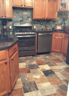 a kitchen with wood cabinets and tile flooring