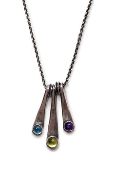 Turn heads with this lovely necklace!  Sterling silver wedges adorned with gemstones dangle elegantly from a sterling chain. Recycled sterling wire is hand-forged (hammered) to shape.  A 5 mm peridot, 4 mm amethyst, and 4 mm lab sapphire add pops of color. A patina is added to the silver to give a vintage look and highlight the hammer marks. Chain is 16 inches with an optional 2 inch extension...allowing you to wear it at whatever length you like. Each necklace is handcrafted in my Montana studio, and sent to you carefully packaged in a lovely gift box.  Enjoy! You'll want the coordinating earrings: https://www.etsy.com/listing/616905097/silver-dangles-long-earrings?ref=shop_home_active_1 or: https://www.etsy.com/listing/580327351/silver-earrings-hammered-peridot-august?ref=shop_home_activ