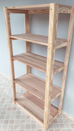 a wooden shelf sitting on top of a tiled floor