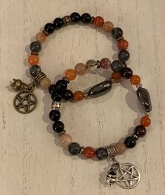 "Happy Halloween and a Blessed Samhain! This beautiful stretch bracelet features a selection of semi precious to aid in communication with the ancestors, increasing intuition, connecting to past, present and future, balance, protection and delving into deep wisdom. Each bracelet will be one of a kind and made to order. A pentacle and tiny cauldron charm set off the bracelet with your choice of antique silver or antique bronze elements. Please know that each bracelet I make is truly one-of-a-kind Spiritual Crystal Bracelet As Gift, Spiritual Crystal Bracelet Gift, Adjustable Spiritual Bracelet For Healing, Spiritual Crystal Bracelet For Gift, Adjustable Spiritual Stretch Bracelet For Healing, Spiritual Beaded Bracelets For Healing, Spiritual Healing Beaded Bracelet With Natural Stones, Mystical Bracelets With Natural Stones As Gifts, Mystical Adjustable Gemstone Beads Bracelets