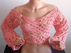 a mannequin wearing a pink crochet top