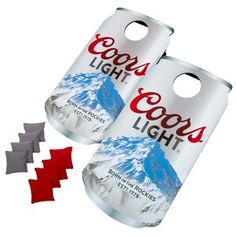 two coca - cola cans with red and gray ribbons around them, one has the word cool's light on it