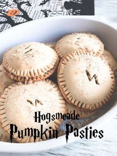 four homemade pumpkin pastries in a white dish with the words hogshead pumpkin pasties