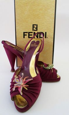 A stunning pair of matte fabric shoes with dimensional enamel orchid & leaf flowers, crystal embellishments. Comes with original box from Bergdorf Goodman. Original price $550. Overall very good condition. Each shoe has light black dots, hard to see unless closely inspected. Purple wine bodies. High heels but with front platform they are more like 3" tall. Size 9.5". Interior toe to heel length: 10.5". Width: 3". Heel: 4.5". Platform: 1". Signed confirmation on delivery. Paypal Payments Only Ple Unique Heels Classy, Flower Shoes Heels, Orchid Shoes, 90s Heels, Purple High Heels, Flower Heels, Purple Heels, Embellished Shoes, Matte Fabric