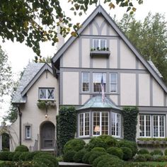 a large house with lots of windows and bushes