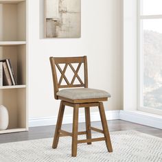 a wooden bar stool sitting on top of a white rug next to a book shelf