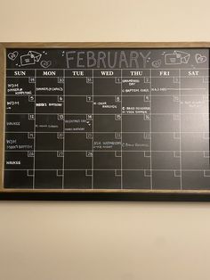 a blackboard with calendars on it hanging on the wall