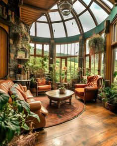 a living room filled with lots of furniture and windows covered in glass roof coverings