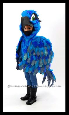 a person wearing a blue bird costume with feathers on it's chest and head