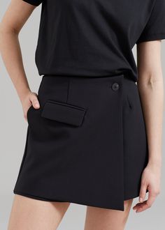 Color: Black Midweight suiting fabric Mini length A-line silhouette Shorts with skirt panel at front Single illusion front flap pocket Concealed back seam zip closure Asymmetric front button closure Partially lined 100% Polyester Dry Clean By The Frankie Shop. Imported Formal Bottoms With Fitted Asymmetrical Hem, Formal Fitted Bottoms With Asymmetrical Hem, Workwear Asymmetrical Skirt With Side Zipper, Asymmetrical Skirt With Side Zipper For Work, Chic Asymmetrical Hem Bottoms For Work, Fitted Asymmetrical Office Bottoms, Fitted Asymmetrical Bottoms For Office, Elegant Asymmetrical Bottoms With Pockets, Black Asymmetrical Hem Bottoms For Work