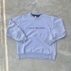 Vintage 1990s Tommy Hilfiger Gray Crewneck Sweatshirt - Size S (Length 26" Chest 22") - Fits SMALL/MEDIUM - Message for more information Please take note of the measurements listed as these are vintage clothes and may fit different than the tag size. Follow our page for more vintage clothing drops! DISCLAIMER: All items are vintage so please be mindful that if by chance there is a flaw on the item we simply may have just missed it. Inquire for more product information. Classic Winter Top With Embroidered Logo, 90s Style Winter Tops With Embroidered Logo, 90s Long Sleeve Tops With Embroidered Logo, Vintage Embroidered Logo Tops For Winter, 90s Crew Neck Top With Embroidered Logo, 90s Crew Neck Winter Tops, 90s Long Sleeve Sweater With Letter Print, Vintage Long Sleeve Tops With Embroidered Logo, 90s Crew Neck Top For Winter