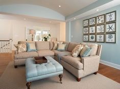 a living room filled with furniture and pictures on the wall