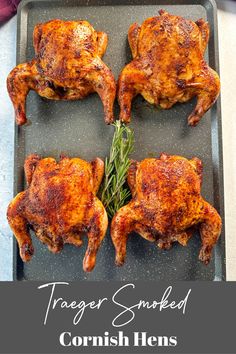 three cooked chickens on a baking sheet with herbs