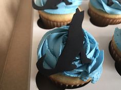 cupcakes with blue frosting and an airplane decoration