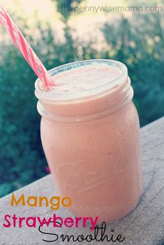 a smoothie in a mason jar with a pink straw sticking out of the top