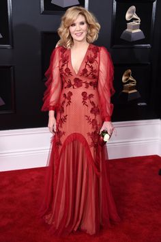 a woman in a red dress on the red carpet