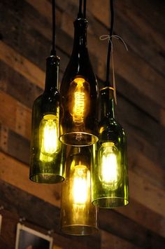 several lights hanging from the ceiling in a room with wood planks behind them and text moon shine lab on top