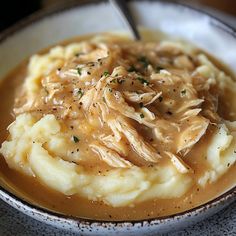 a bowl filled with mashed potatoes and gravy