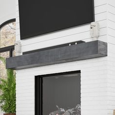 a white brick fireplace with a flat screen tv mounted on it's wall above the fire place