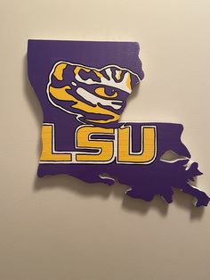 a purple and yellow lsu state shaped cutout on a wall