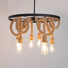 a chandelier with rope and light bulbs hanging from it