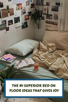 a bed with lots of pictures on the wall above it and an open book laying on top