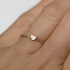 Delicate and comfortable, this little petal ring looks great worn alone as well as stacked with more rings. Makes the perfect wedding ring for the minimalist bride, or an elegant every day ring! Details: -Band - Choose 1.3mm OR 1.6mm Remember, if you are stacking it with one of my 1.6mm thick rings, choose 1.6mm, and if you are stacking it with a 1.3mm ring...choose 1.3mm. This will ensure that they sit flush together without the petal bumping into the side of the other ring causing a gap. -Peta Dainty Engraved Ring For Everyday, Dainty Engraved Stackable Ring, Dainty Adjustable Tiny Heart Ring, Tiny Delicate Heart Promise Ring, Delicate Tiny Heart Promise Ring, Dainty Engraved Stackable Rose Gold Ring, Dainty Rose Gold Stackable Engraved Ring, Dainty Rose Gold Engraved Stackable Ring, Delicate Heart Promise Ring