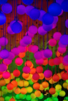 colorful lights hanging from the ceiling in a room