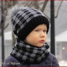 a little boy wearing a knitted hat and scarf