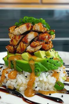 a white plate topped with rice covered in sauce and chicken on top of avocado