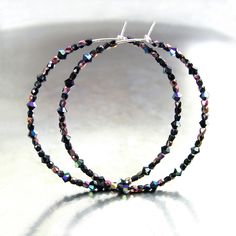 "Dainty and lightweight round hoop earrings featuring tiny (2-3mm) sparkly, faceted Swarovski and Czech crystals, in 'Black Aurora\", strung unto 21 gauge .925 Sterling Silver wire. You have a choice of 20mm, 30mm, 45mm, 55mm, 65mm or 75mm diameter hoops. More HOOP EARRINGS, in my shop: https://www.etsy.com/shop/DorotaJewelry?ref=hdr_user_menu-shop&section_id=28150357 --- All of the designs in my shop are handmade by me in my Virginia studio. Elegant GIFT BOX is included with your order YOU CAN ENTER MY SHOP HERE: http://www.etsy.com/shop/DorotaJewelry Copyright © 2025 Dorota Sularczyk. All Rights Reserved." Black Aurora, Earrings Dainty, Czech Crystal, Beaded Hoop Earrings, Beaded Hoops, Swarovski Earrings, Earrings Boho, Silicone Beads, Jewelry Earrings Hoops